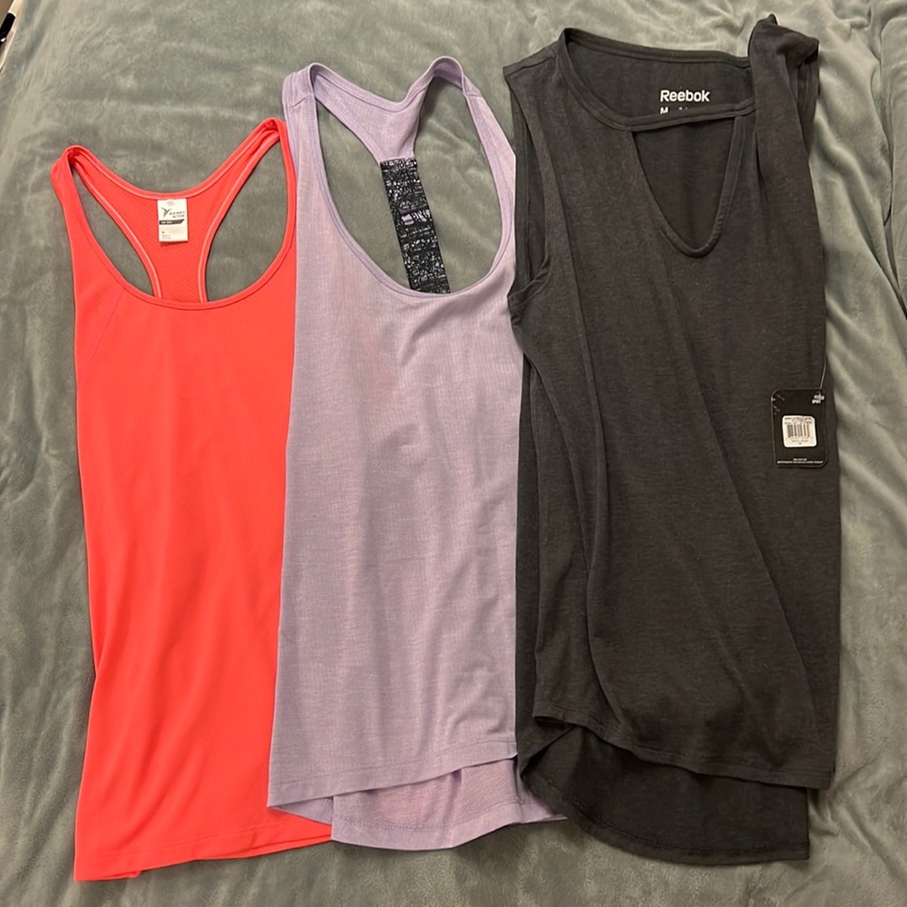 3 GUC workout tanks, 2 Under Armour and 1 Reebok NWT